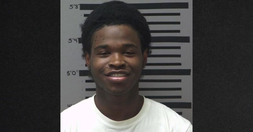 Khalil Pugh smiled for his police mug shot after being arrested on murder charges.
