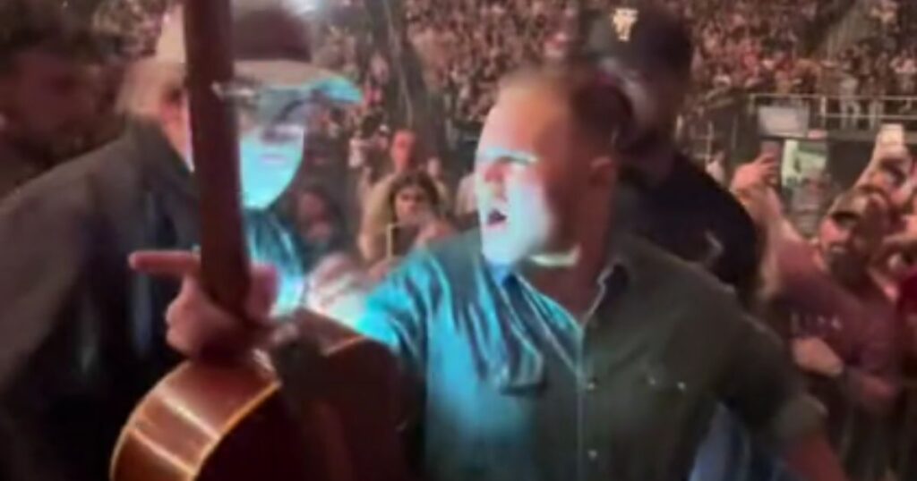 Country star Zach Bryan removes a fan after she tried to grab his guitar at an Albany, New York, concert.